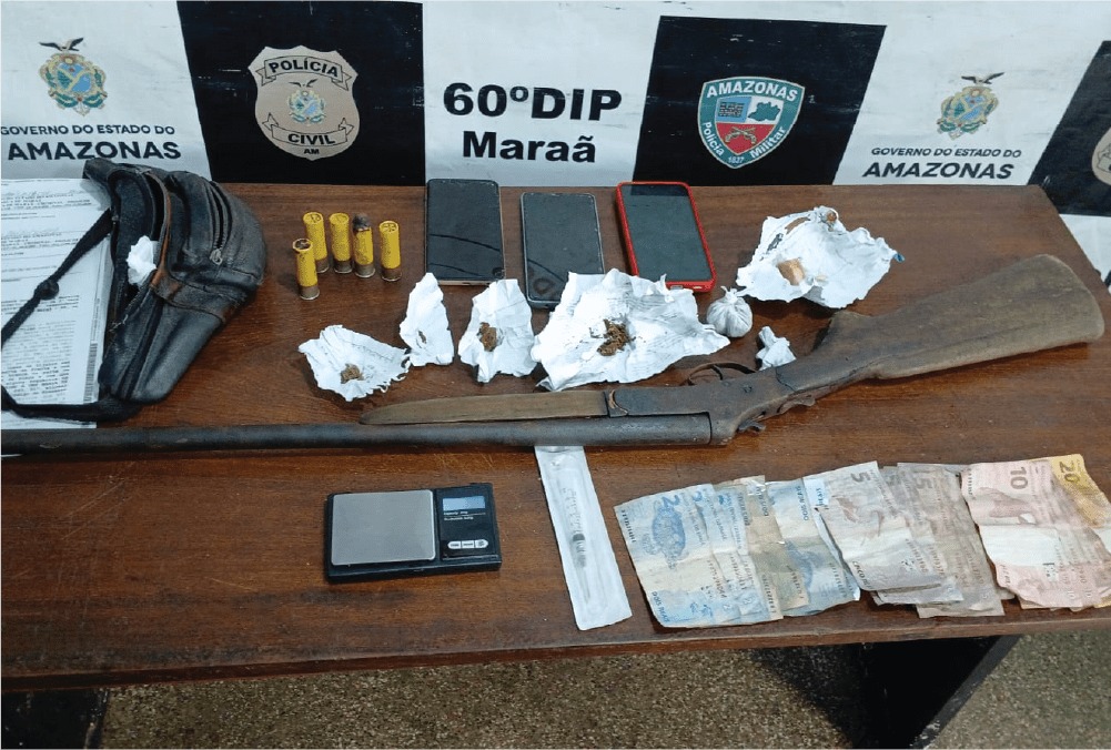 A man was arrested after being caught carrying drugs and firearms inside AM