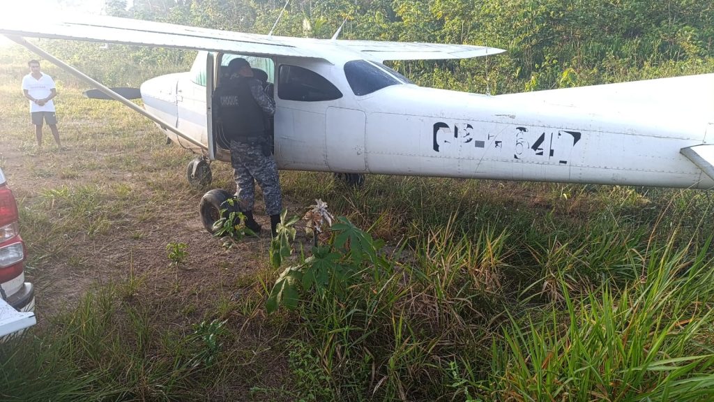 Policiais do Batalhão de Choque ao lado da aeronave apreendida com 300 kg de cocaína em Novo Aripuanã